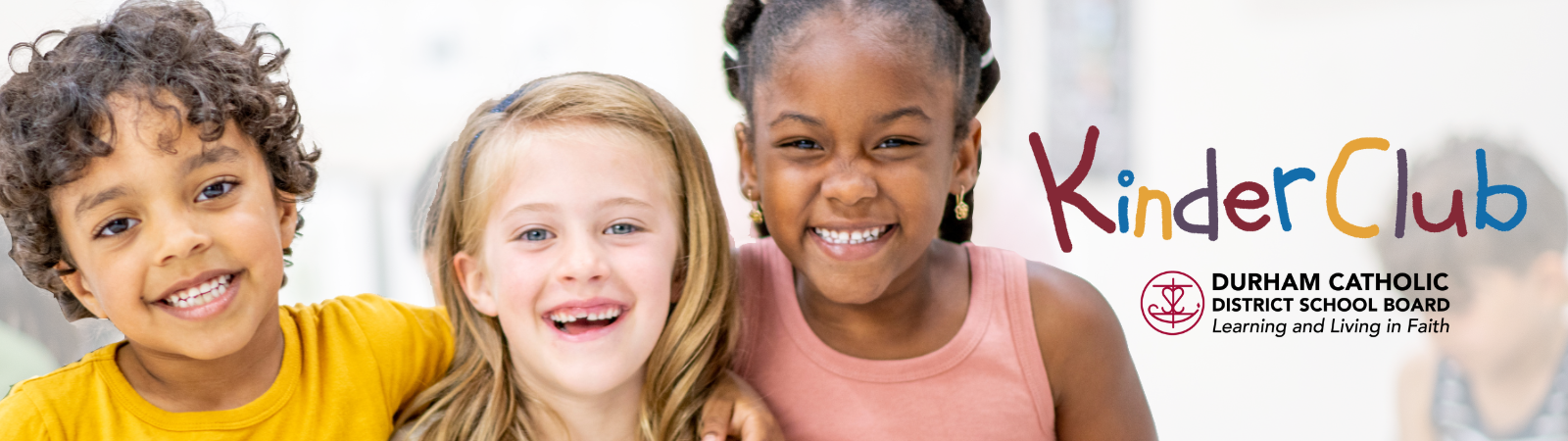 3 Kindergarten students smiling together