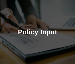 Person with a clipboard and a pen. Overlay text reads Policy Input