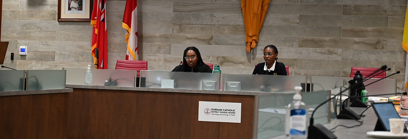 Two female student trustees in the boardroom