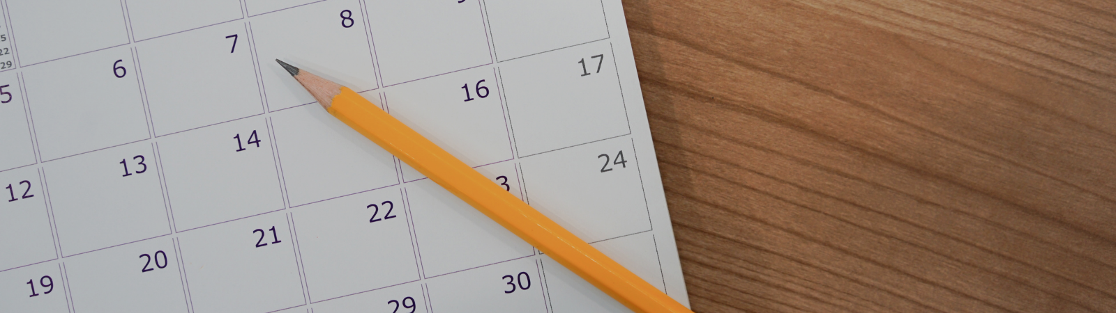 calendar and a pencil on a wooden desk