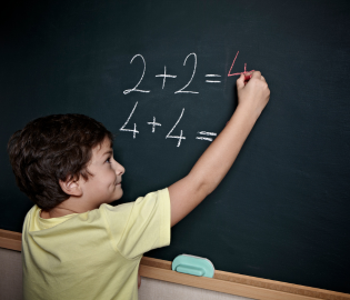 Young boy doing math problem