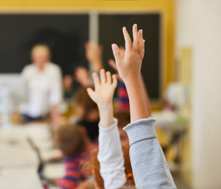 Hands raised in a classroom