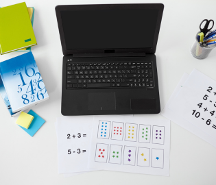 Open laptop and textbooks on a desk