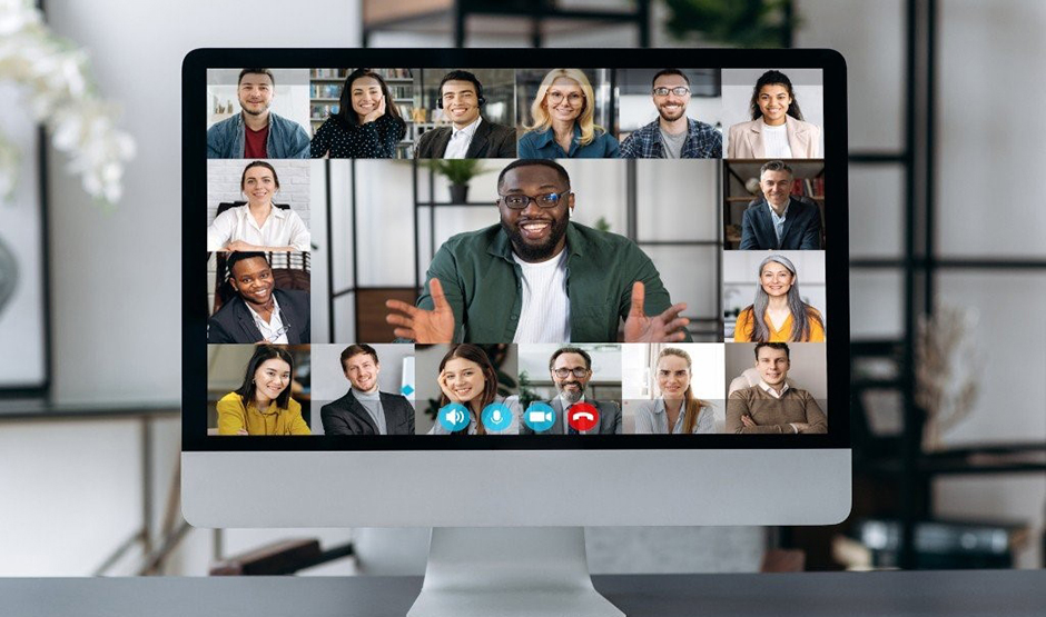 Desktop computer with images of people participating in a virtual meeting