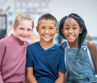 Three students smiling together