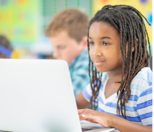 student on laptop in class