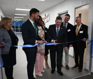 people cutting a ribbon