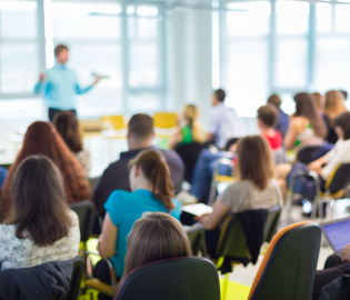 A group of people watching a presentation