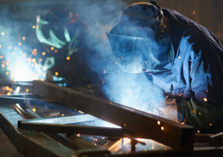 Person welding wearing welding gear