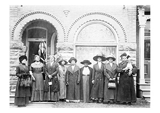 Group of Black Women standing in front of a building