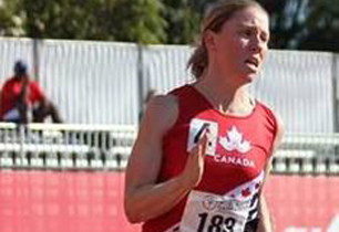 Female adult running and wearing a Team Canada shirt