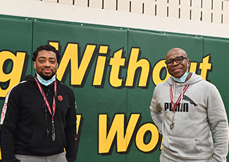 Two male adults smiling