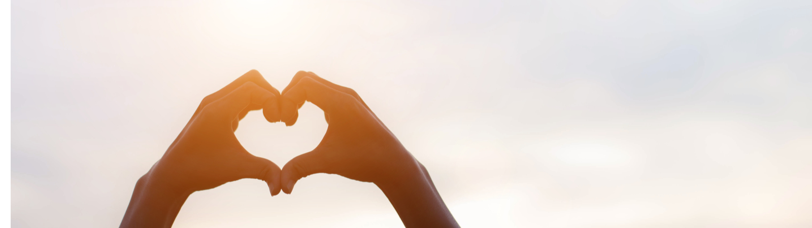 hands forming a heart in the sky