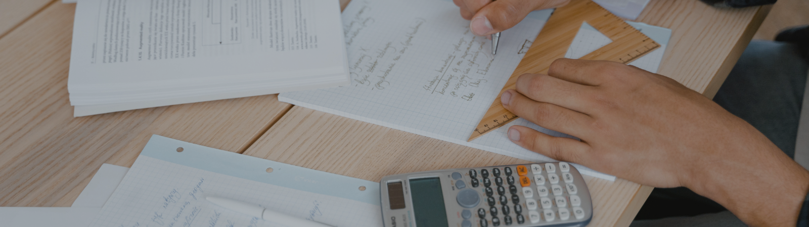 person doing math homework with a protractor