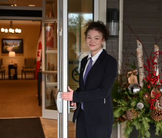 student holding door open