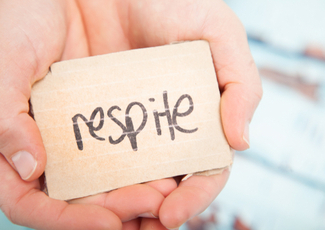 Hands holding a sign that says respite