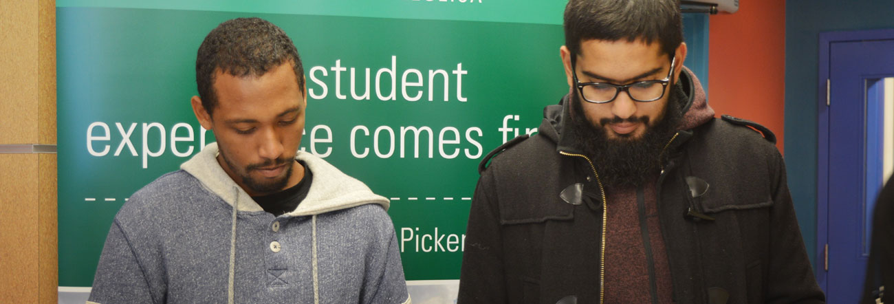 Two students sitting beside each other