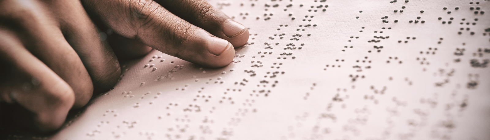 fingers reading braille