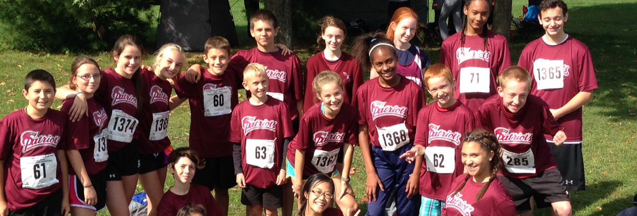 Male and female students outside in their school athletic uniform