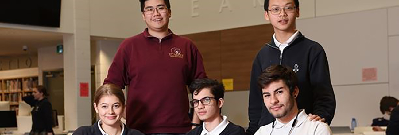 A group of male and female international students in uniform