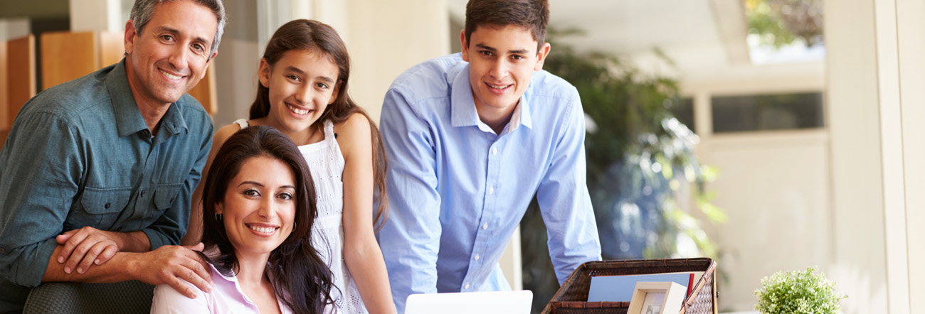 Male and female adults with daughter and son smiling