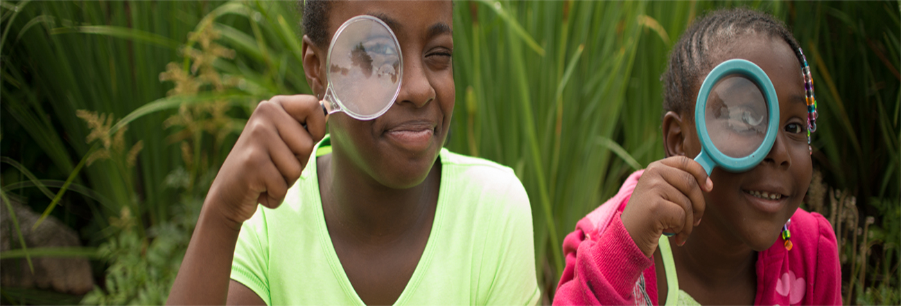 Two girls holding mega find glasses