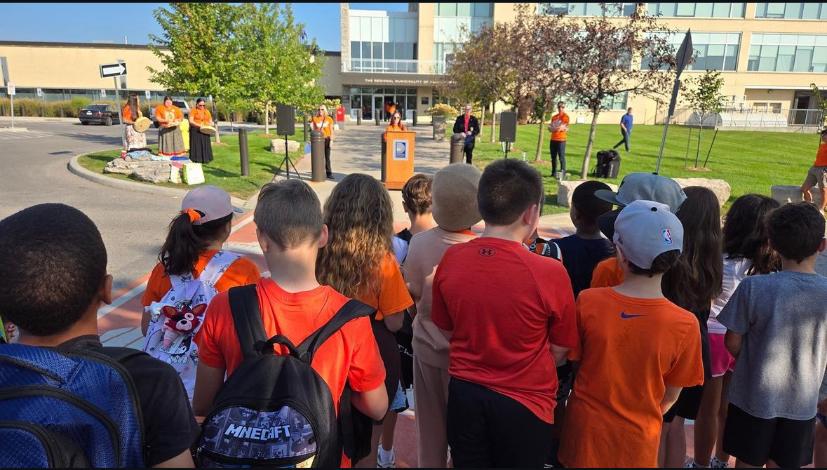 kids in orange shirts walking