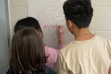kids writing on a board