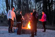 people standing around a fire