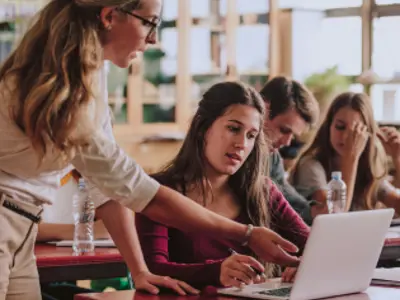 Teacher helping students
