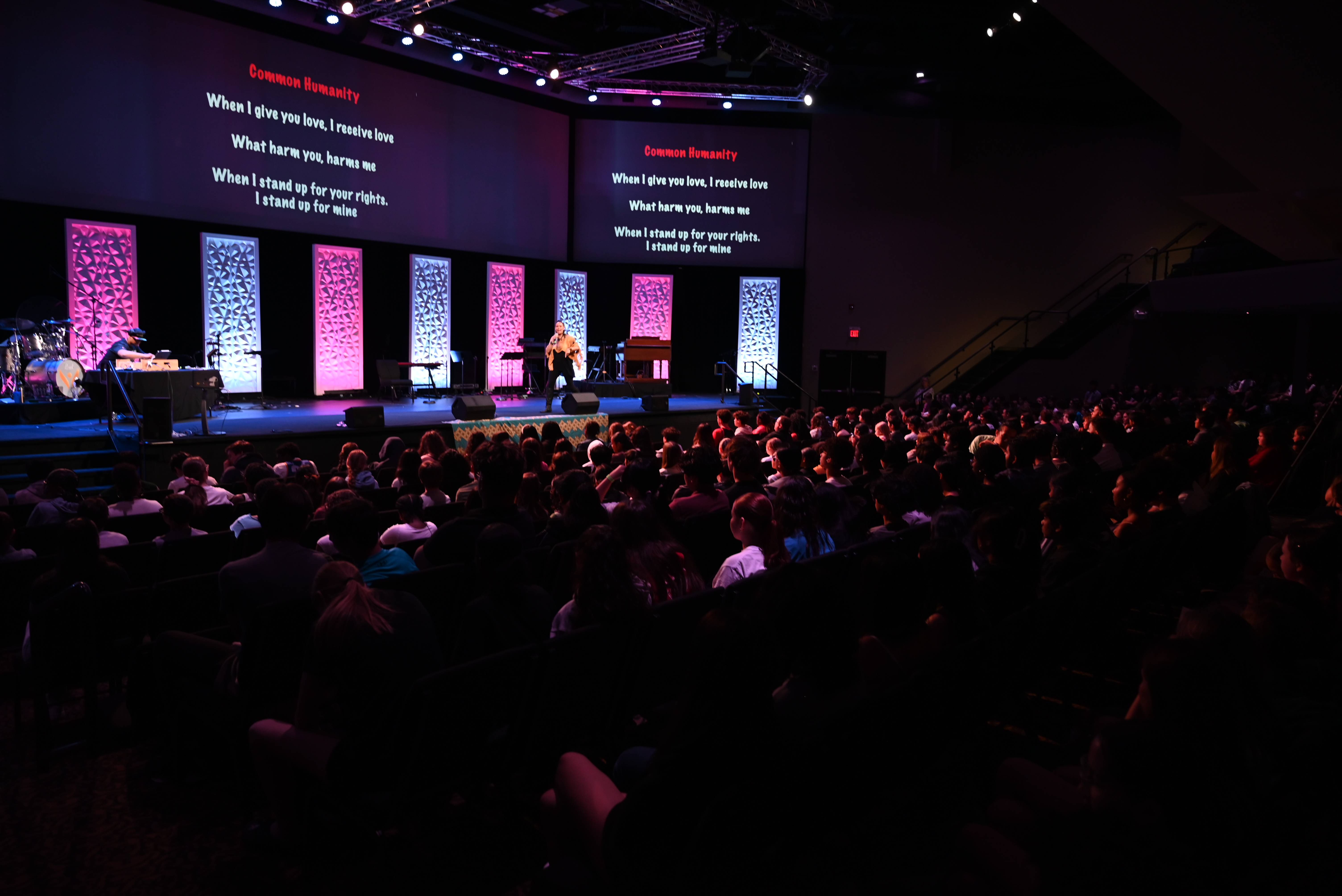Students watching a presentation in a theatre