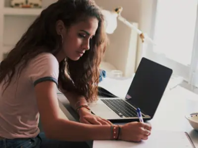 Student doing homework on a laptop