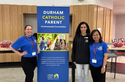 People standing in front of a banner