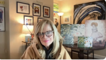 Adult woman sitting in front of paintings