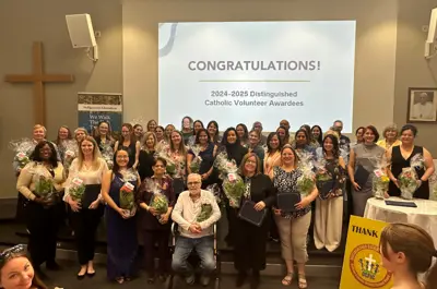 Large group of people in front of a screen