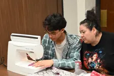 two people at a sewing machine